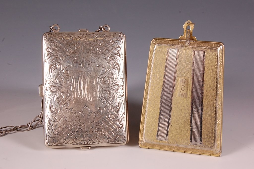 TWO MINIAUDIERES, ONE BY EVANS: Embossed silvertone miniaudiÃ¨re with a chain handle, leather pocket in the lid with two calling cards for 'Mrs. Samuel Frederick Garrison', mirror on a leather hinge with a writing pad and mechanic
