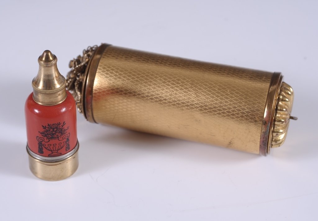 BOLSTER NECESSAIRE W FILIGREE & PERFUME/COMPACT DUO: Goldtone filigree with jewels compact with a mirrored lid with mesh sifter on one end of a bolster shaped necessaire, the other end holds a cylinder purse that inserts in the case, sides are gold card