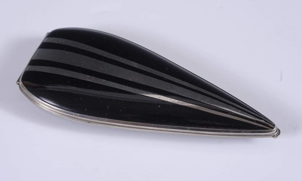 ELGIN AMERICAN ARROWHEAD SHAPE DUO COMPACT: Black enamel on silvertone, framed mirror in the lid, hinged powder and rouge wells with a rouge pan, branded powder puff, marked on the powder well lid, measures 4.5 x 2 inches.