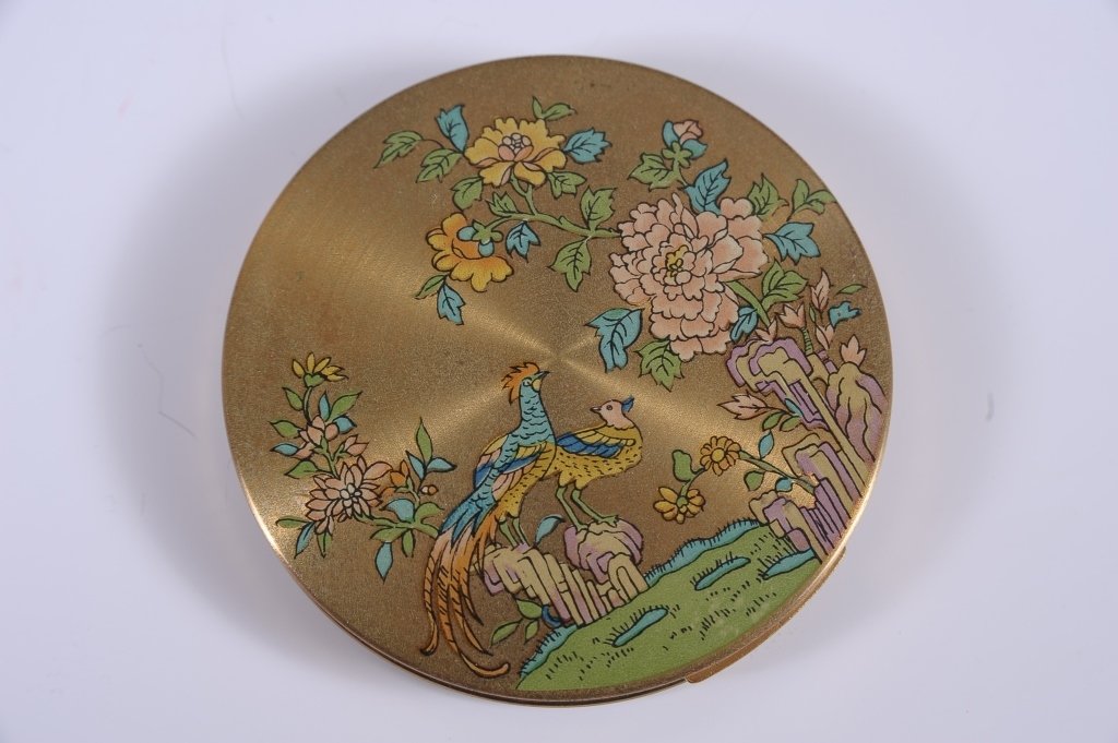 ZENETTE COMPACT: Goldtone compact with decal top of birds and a garden, framed mirror in the lid, hinged powder well in the base, mesh sifter and puff, marked on the powder well lid, English, measures 3 inches.