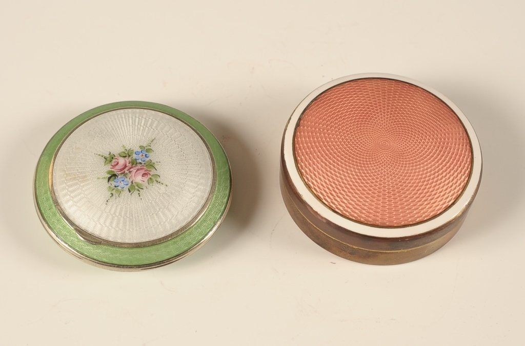 TWO GUILLOCHE COMPACTS: Green and white guilloche compact with a painted floral spray, framed mirror in the lid, powder well with pan, no puff, unmarked, measures 2.25 inches, good. And a coral and white guilloche topped com