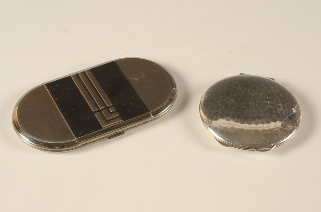 LUCIEN LELONG PLATINUM PLATED & .835 COMPACTS: a Lucien LeLong platinum plated duo compact with the maker's logo on the top, framed mirror in the lid, the base holds a hinged rouge well with original shaped puff and rouge pan, hinged powder well w