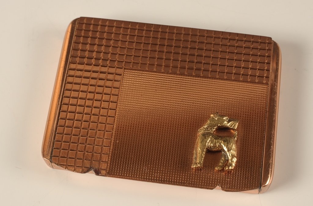 COPPER COMPACT WITH TERRIER: Goldtone terrier on the top, beveled mirror in the lid, mesh sifter and puff, unmarked, measures 2.5 x 3.25 inches.