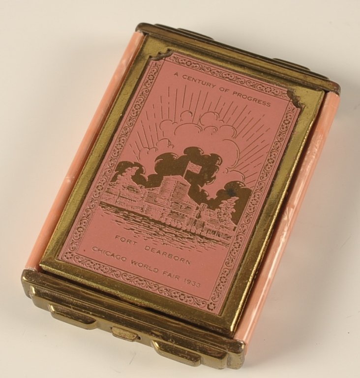 1933 CHICAGO WORLD'S FAIR ENAMELED COMPACT: Girey compact with pearlescent base and pink enamel on goldtone lid, depicting Fort Dearborn at the 1933 Chicago World's Fair, pop up lid, beveled mirror in the lid, base holds a rouge well with pan a