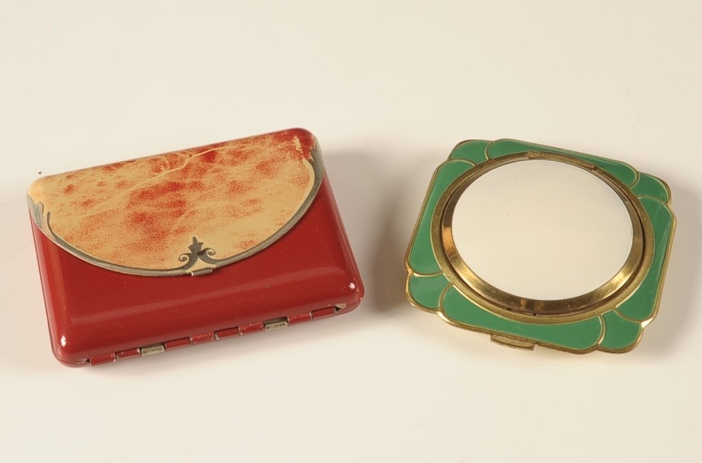 ENAMELED MINIAUDIERE & ENAMELED COMPACT: Red enameled miniaudiere in a clutch purse design, hinged metal mirror over a cigarette compartment with clip in the lid, base holds a hinged powder well with puff, rouge well with pan and puff in cel