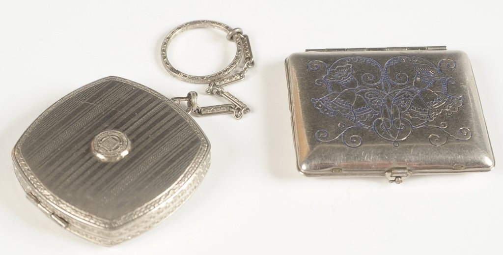 KARESS COMPACT & UNIVERSITY OF PENNSYLVANIA COMPACT: Karess compact with embossed bell flowers on the top, framed mirror in the lid, branded puff, marked on the mirror frame, measures 1.75 x 2 inches, good. Plus a duo compact for the University of Penns