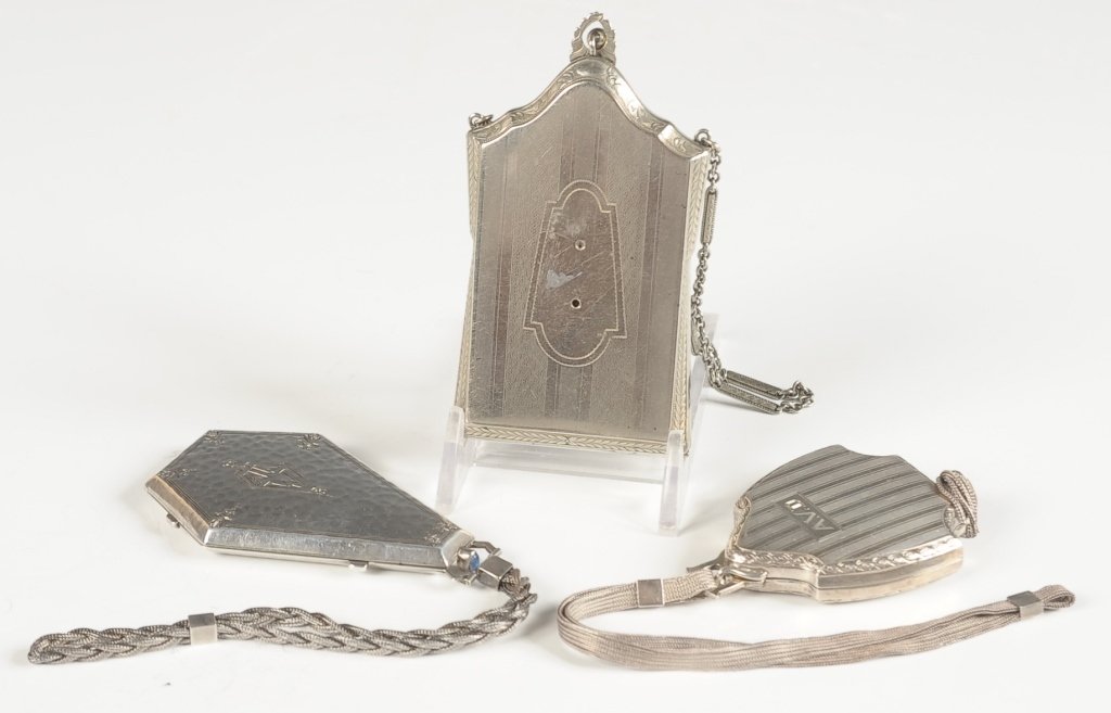 TWO STERLING COMPACTS & A MARATHON VANITY CASE: The Thomae Co. sterling compact with a 6 inch mesh chain handle, monogrammed 'AVD' on the top, framed mirror in the lid, marked in the inside lid, measures 2.5 x 1.75 inches, 9 inches from handle to t