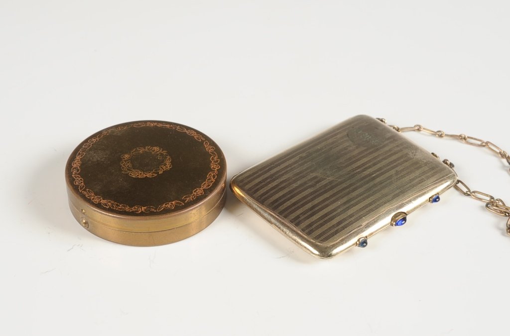 MINIAUDIERE WITH CHAIN HANDLE & GOLDTONE COMPACT: Miniaudiere case with chain handle with finger ring, hinged mirror with writing pad on the other side over a cigarette compartment with hinged clip, two hinged powder wells on the other side, measures