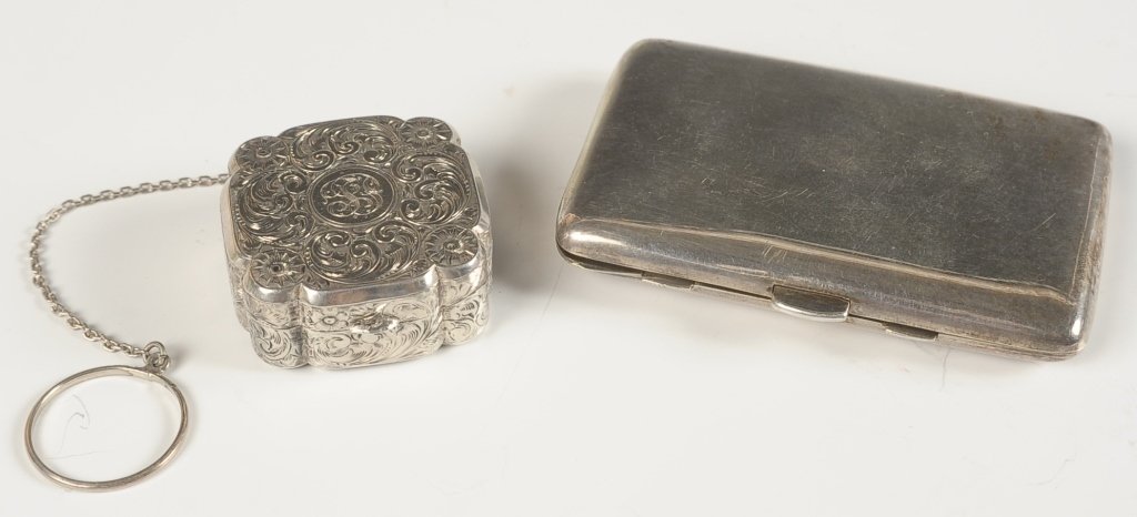 SMALL STERLING CHASED COMPACT AND DUO COMPACT: Small sterling compact with all over chased design with monogram, chain with finger ring, framed mirror in the lid, marked on the rim, measures 1.5 inches on a 5 inch chain. Plus a duo compact with fr
