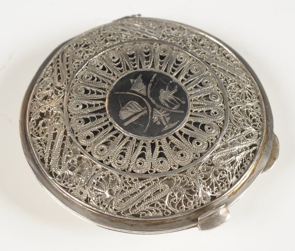 SILVER FILIGREE COMPACT WITH EGYPTIAN ETCHINGS: Filigree overlay lid over a compact with Egyptian designed etching, framed mirror in the lid, unmarked, measures 3 inches.
