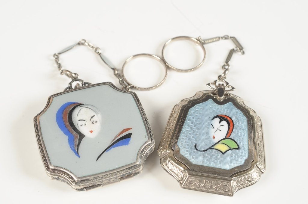 STERLING ENAMELED COMPACT W PAINTED FACE & ANOTHER: R&G Co. La Mode sterling enameled compact with a painted woman's face on the top, enameled chain handle with a finger ring, framed mirror in the lid, rotary powder sifter in the base with a rouge well