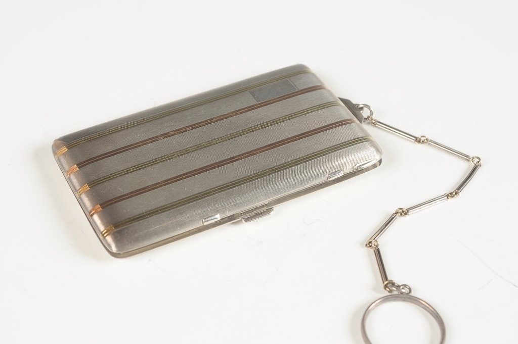 BLACK, STARK & FROST STERLING & 14KT DUO COMPACT: With a chain handle and finger ring, mirror frame in the base (mirror is missing), hinged rouge and powder wells in the other side, marked on the rouge well lid, measures 3.5 x 2 inches on a 5.25 inch