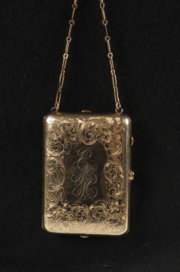 F&B GOLD-FILLED MINIAUDIERE: Hand chased floral designs on top with a monogram, chain handle and finger ring, lid holds a hinged mirror with a notepad and mechanical pencil on the other side, base holds to hinged powder wells, ma