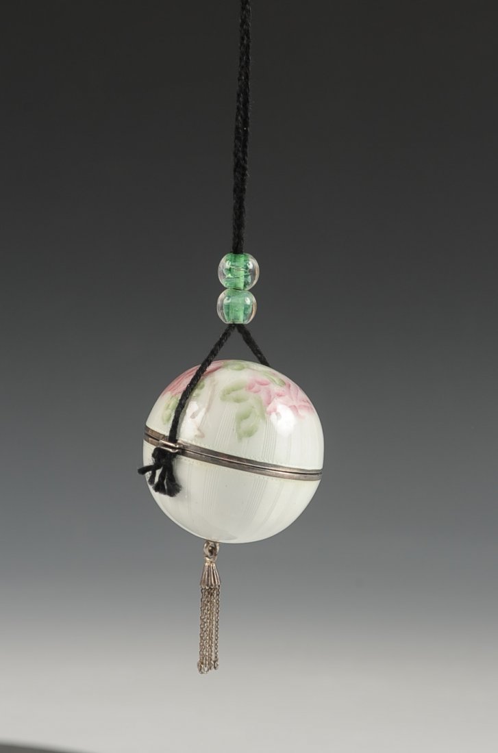 F&B STERLING GUILLOCHE BALL-SHAPED COMPACT: F&B white guilloche with painted florals, hinged ball-shaped duo compact with a cord handled with beads acts as a closure, silver tassel, opens to reveal hinged mirrors over rouge and powder wells, tw