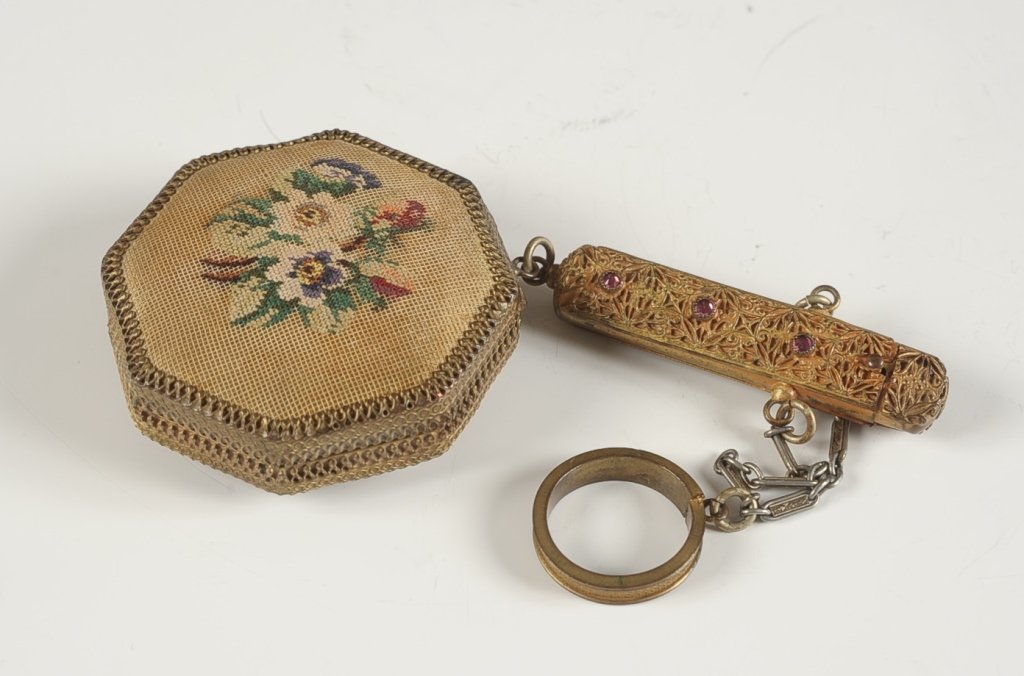 PETIT POINT COMPACT W LIPSTICK FOB & FINGER RING: Petit point florals top and bottom of the compact with jeweled filigree lipstick fob under a finger ring on a chain, duo compact has a rouge well under a hinged mirror in the lid, powder well in the b