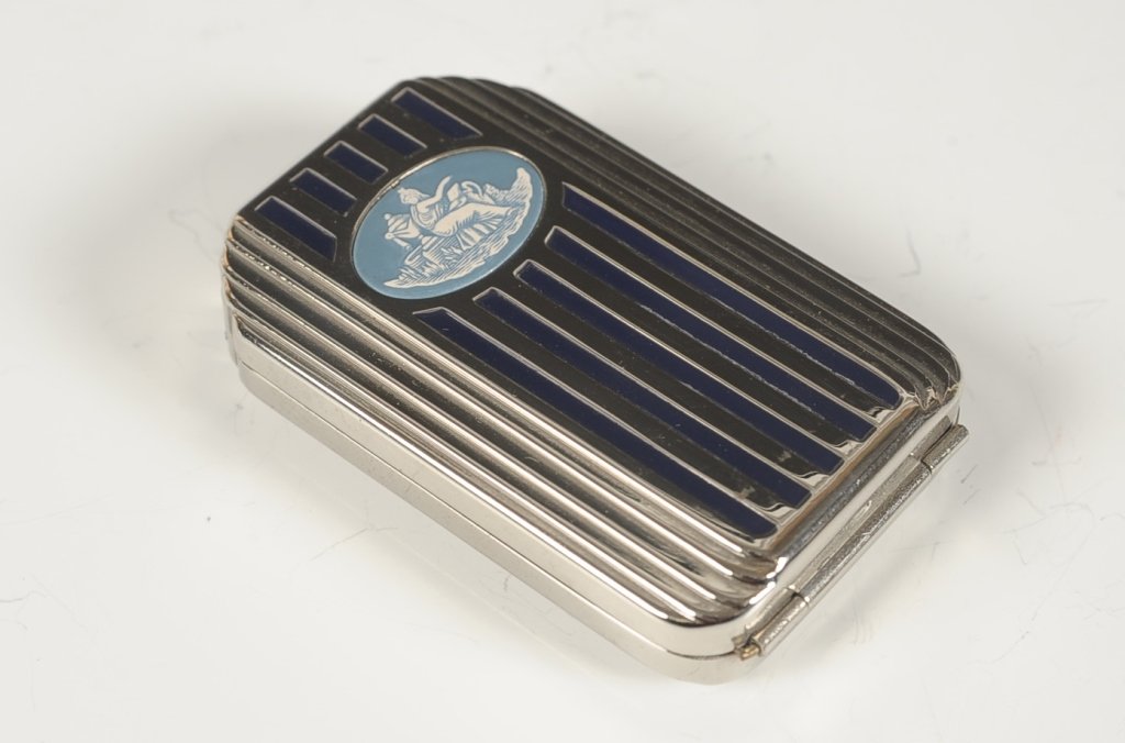 DOROTHY GRAY FIFTH AVE DUO COMPACT W ORIGINAL BOX: Silvertone with blue enamel and a porcelain medallion classical scene with it's original hinged presentation box, hinged double-sided mirror over a rouge well with pan and branded puff in the lid, bas