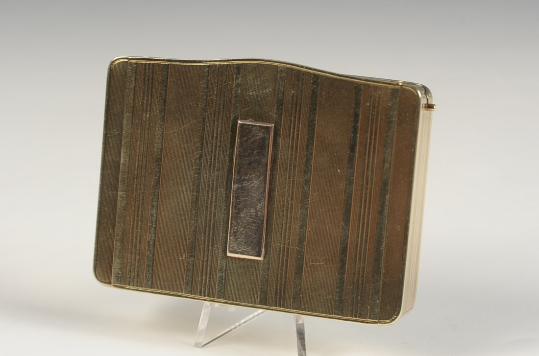 14KT GOLD VANITY CASE W LIPSTICK & PERFUME: 14kt gold compact with an external lipstick and perfume flask on each side, mirrored lid, two wells in the base, marked on the mirror frame, measures 2 x 2.75 inches, weighs 84 grams.
