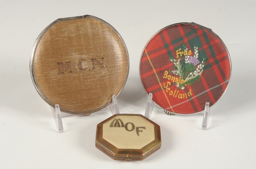 THREE VINTAGE COMPACTS: Free Bonnie Scotland' compact with embroidered plaid top, plaid puff and mesh sifter, measures 3 inches, excellent unused condition. Plus a wood top compact monogrammed on top, measures 3.25 inches, g