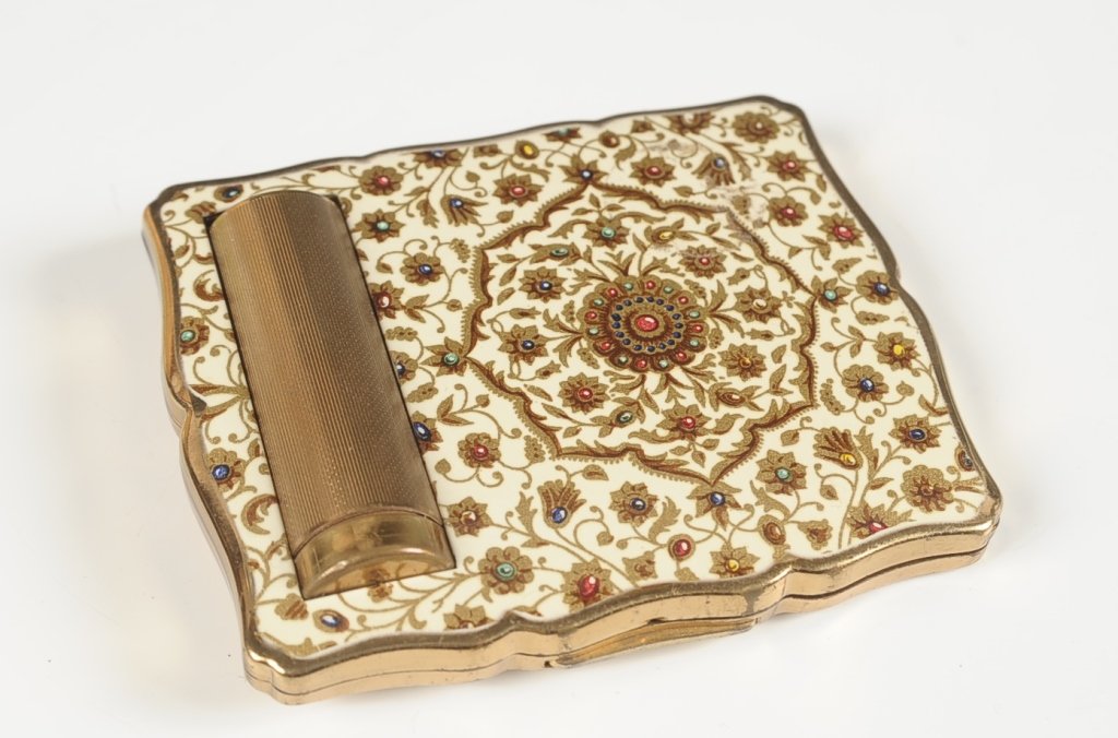 STRATTON ENAMELED COMPACT W PEEK THROUGH LIPSTICK: Framed mirror in the lid, hinged powder well with mesh sifter, marked on the powder well lid and the lipstick, measures 3.75 x 3.25 inches.