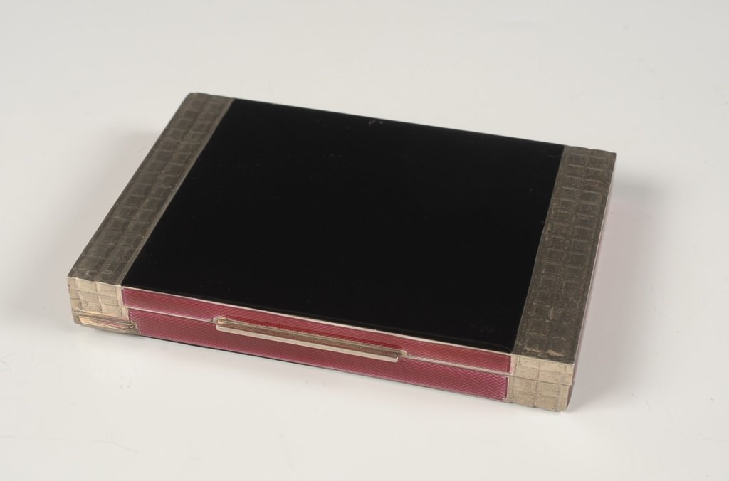 LARGE .800 SILVER AND ENAMEL MINIAUDIERE: Black enamel on .800 silver miniaudiere with ruby enamel on the hinged compartments on the inside, mirror in the lid, wells for cigarettes, lipstick, comb, rouge and powder in the base, marked on the 