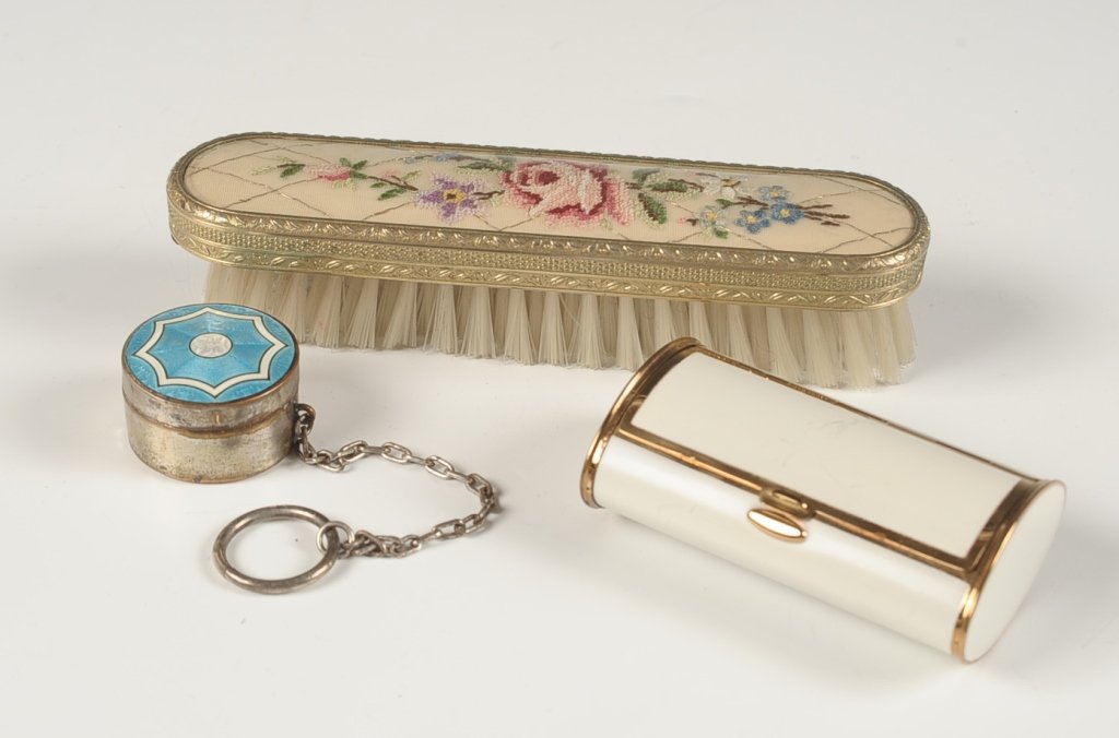 SHEFFIELD SILVER GUILLOCHE COMPACT, MORE: Sheffield silver guilloche compact with chain and finger ring, mirrored lid, puff, unmarked, measures 1.25 inches, weighs .7 ozt., good. Plus a white enamel bolster-shaped compact, measures 1 x 3.25 i