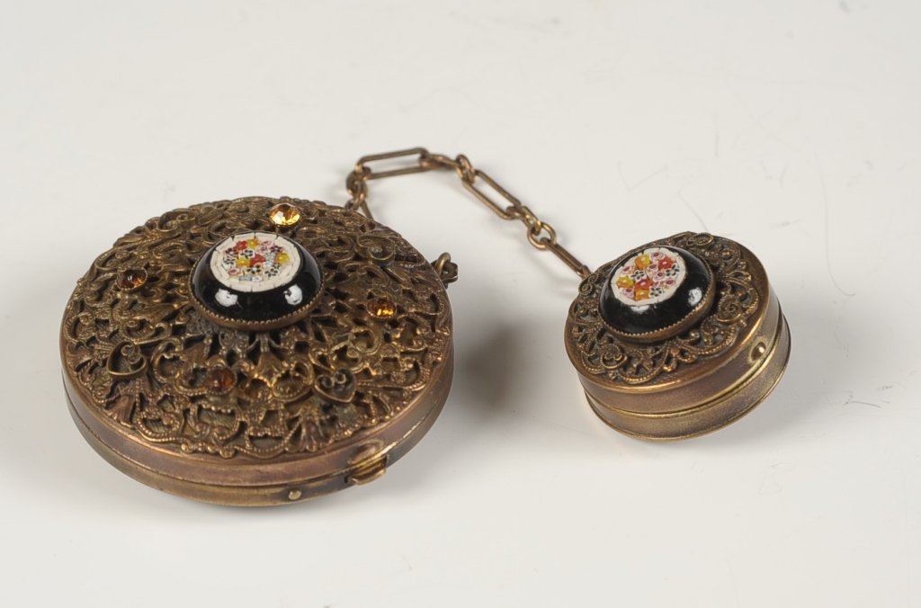 FILIGREE COMPACT W MICROMOSAIC & COMPACT FOB: Jeweled filigree compact with a micromosaic center with millefiore, chain handle with a smaller compact fob with jewels and micromosaic, mirrors in the lids, unmarked, compacts measure 1 and 2 inches,