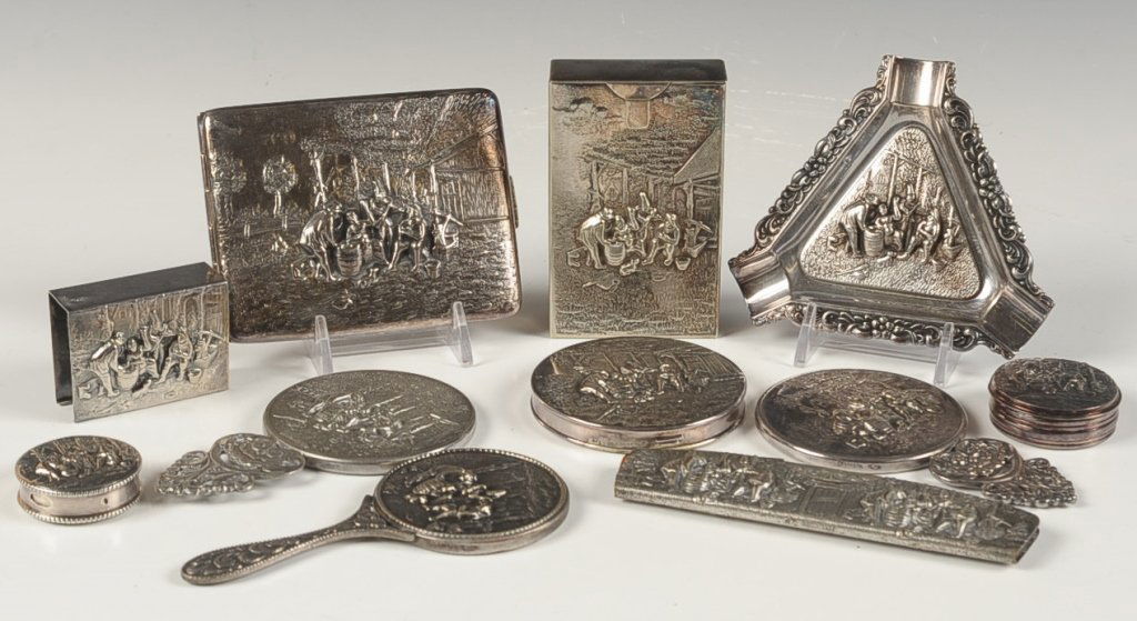 ELEVEN PIECE VANITY SET WITH DUTCH SCENE: Silver plate set marked Zilpla 90 with an embossed Dutch scene on each piece, includes three hand mirrors, cigarette case, pill box, flip comb, small and large compacts, cigarette pack case, ashtray a