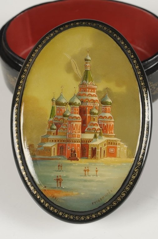 RUSSIAN LACQUER BOX WITH ST. BASIL'S CATHEDRAL: Oval box signed at the bottom edge and dated 1991, measures 1.75 x 3.5 x 2.25 inches.