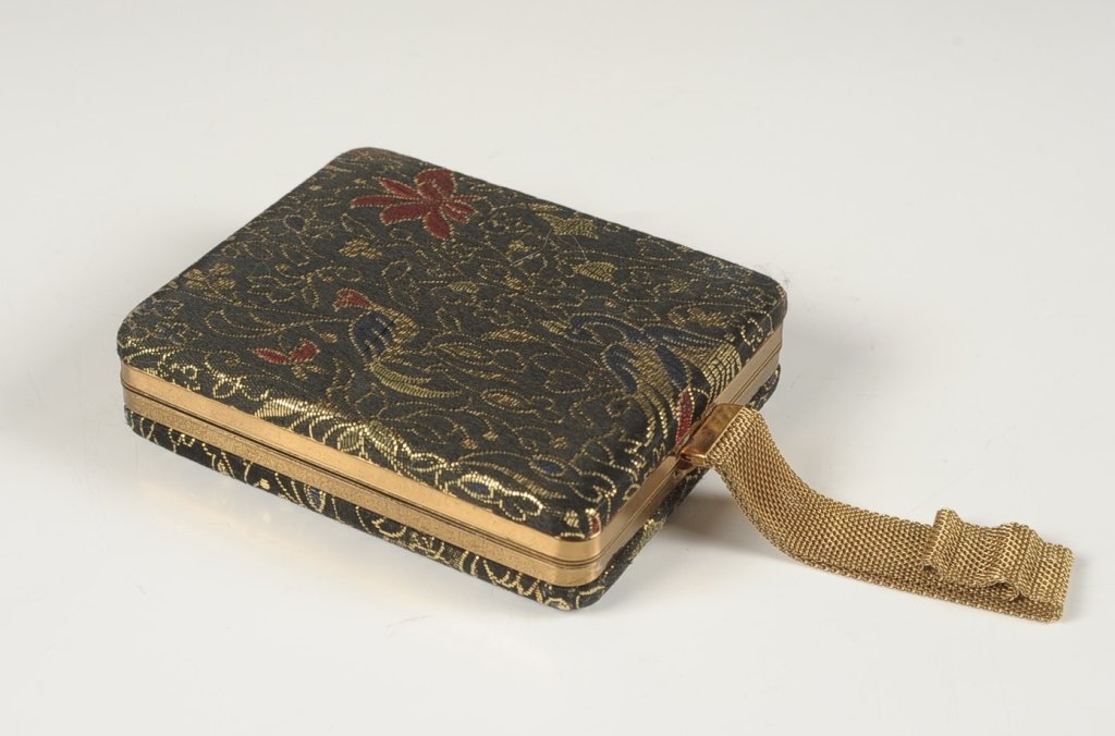 ZELL FIFTH AVE. BROCADE VANITY CASE: With mesh chain handle, goldtone frame, coin purse in the lid, pockets for a lipstick and compact in the base, goldtone compact with mirrored lid and hinged powder well, marked on the coin purse, meas
