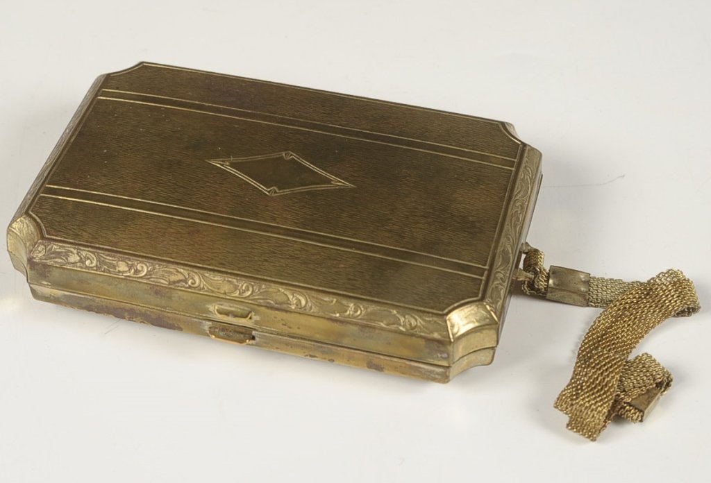 DERMAY 'COMBINATION VANITY' CASE WITH ORIGINAL BOX: Goldtone vanity case with a mesh handle, hinged mirror over a compartment in the lid with wells for kohl or lipstick on each side, base holds a powder well with puff, rouge well with puff and pan and 