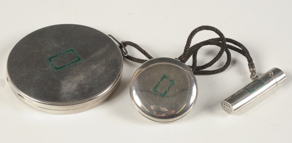 STERLING COMPACT WITH ROUGE AND LIPSTICK FOB: Sterling compact with a rouge compact has a handle with a lipstick fob all connected with a cord, powder compact with framed mirror and powder pan, marked on the rim, rouge compact with mirror, pan an