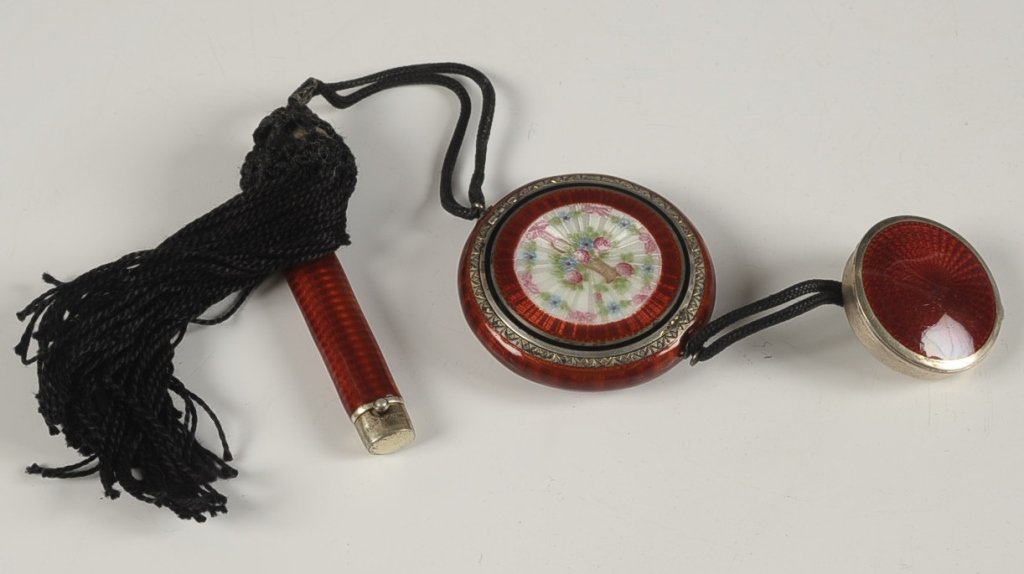 F&B STERLING RED GUILLOCHE COMPACT WITH ROUGE FOB: F&B Co. sterling red guilloche compact with painted florals on top, guilloche rouge attached with a cord acts as a handle, guilloche lipstick concealed in a cord tassel, marked on the lid rims and on 