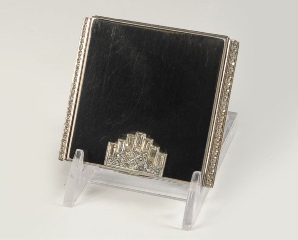 FOSTER BLACK ENAMEL VANITY CASE WITH JEWELED TOP: Framed mirror in the lid, hinged powder well with branded puff, hinged well with rouge and lip rouge, marked on the well lid, measures 2.25 x 2.5 inches.