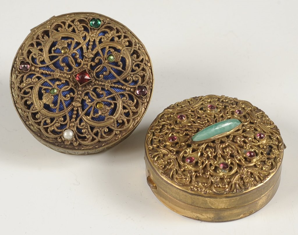 AUSTRIAN FILIGREE COMPACTS W JEWELED TOP & ANOTHER: Austrian filigree compact over blue satin with assorted jewels, framed mirror in the lid, marked on the bottom, measures 2 inches, very good, mirror is crazed and has some silvering loss. Plus a filig