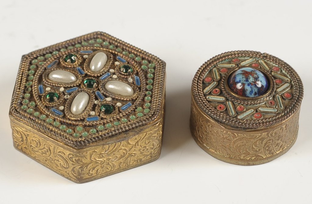 TWO SMALL FRENCH FILIGREE COMPACT PENDANTS: Filigree with jewels and enameling, framed beveled mirrors in the lid, puff in the smaller compact, larger marked on the bottom, measure 1.5 and 1 inches.