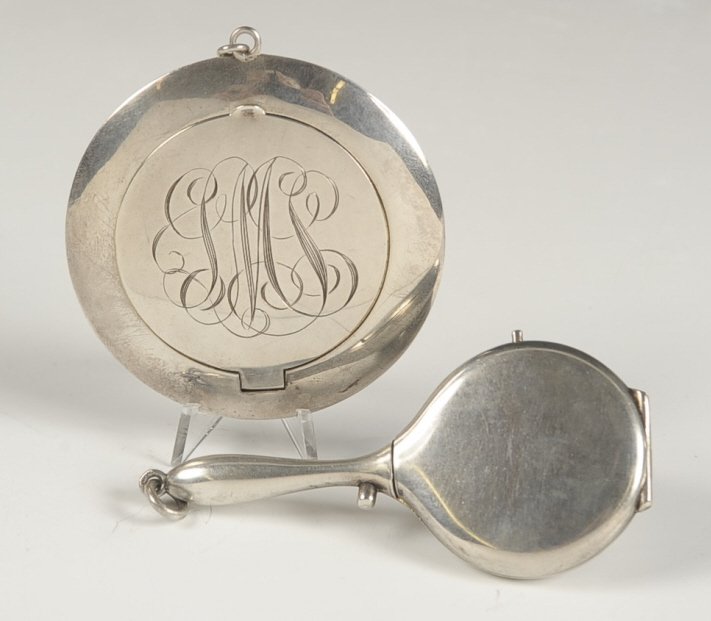 STERLING COMPACT & .800 SILVER COMPACT: Sterling compact, monogrammed on top, mirror lid, puff present, marked on the bottom, measures 2.75 inches, weighs .95 ozt. Plus a .800 silver compact shaped as a hand mirror, mirrored lid, hinged pow