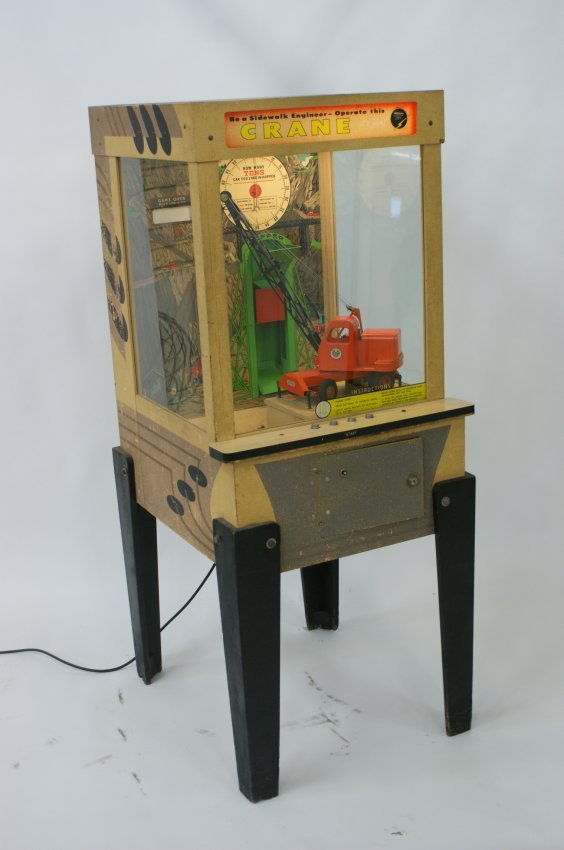 WILLIAMS COIN-OP ARCADE GAME WITH TOY CRANE BY MODEL: All original 10 cent arcade game with a MODEL TOYS brand crane that can be operated to load material in a hopper at the back of the compartment. A scale just above the hopper registers the number of t