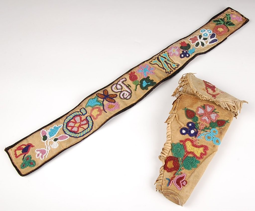 SANTEE SIOUX BEADED BELT & HOLSTER: Beaded strip measuring 22 x 3 inches, accompanied by a native tanned holster measuring 9 x 5 inches with commercial tanned belt loop. Purchased at the C.M. Russell Museum.