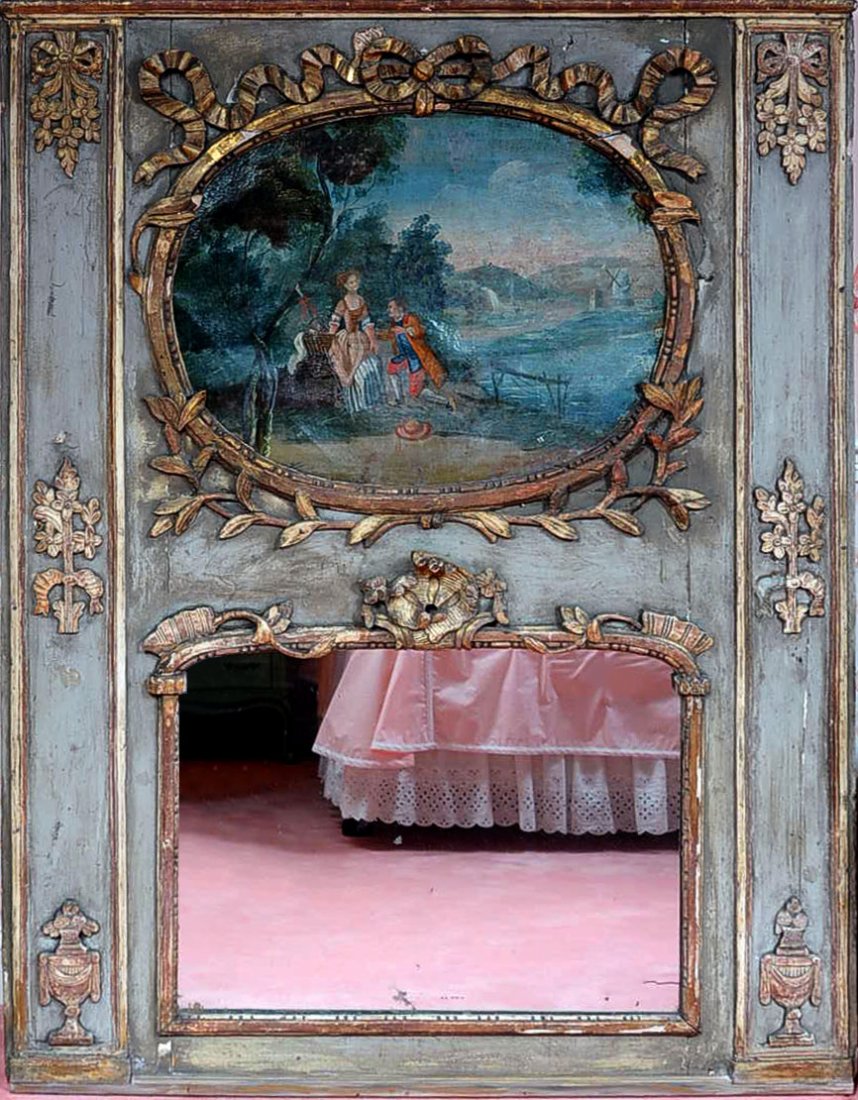 18TH C. FRENCH TRUMEAU MIRROR FROM A PANELED ROOM: An 18th century French trumeau mirror with oil on canvas painting over mercury glass mirror, applied ribbon and bow carvings, floral, wreath and urn motifs. Nice old green painted surface with gilding