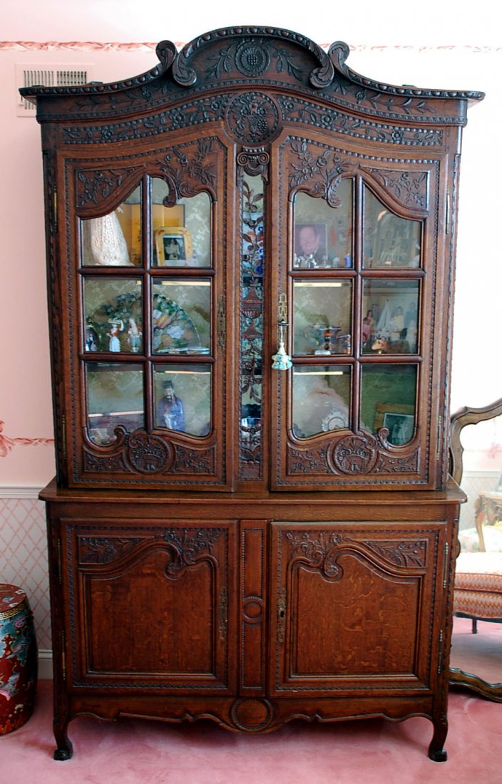 AN EARLY 19TH C. COUNTRY FRENCH BUFFET A DEUX CORPS: A classic example of the Buffet a Deux Corps (“buffet with two bodies”) intricately carved from oak hard wood, a difficult medium for the degree and quality of carving here - note the open work ca