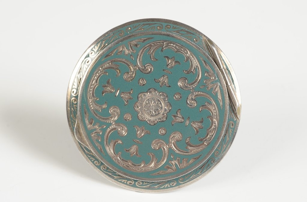 AUSTRIAN CHAMPLEVE ENAMEL COMPACT: Green champleve enamel on sterling in a chased design, beveled mirror in the lid, marked inside the base, measures 2.25 inches, weighs 1.6 ozt.