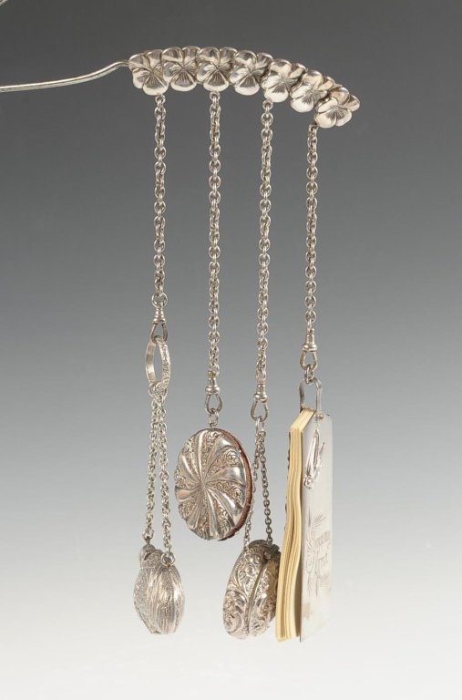 ASSEMBLED CHATELAINE BROOCH WITH BIRD PERFUME: Brooch pin with pansies with four dangles holding a 'Shopping List' note pad with a mechanical pencil, a compact marked sterling, compact is monogrammed, a pincushion, and a figural bird that opens to