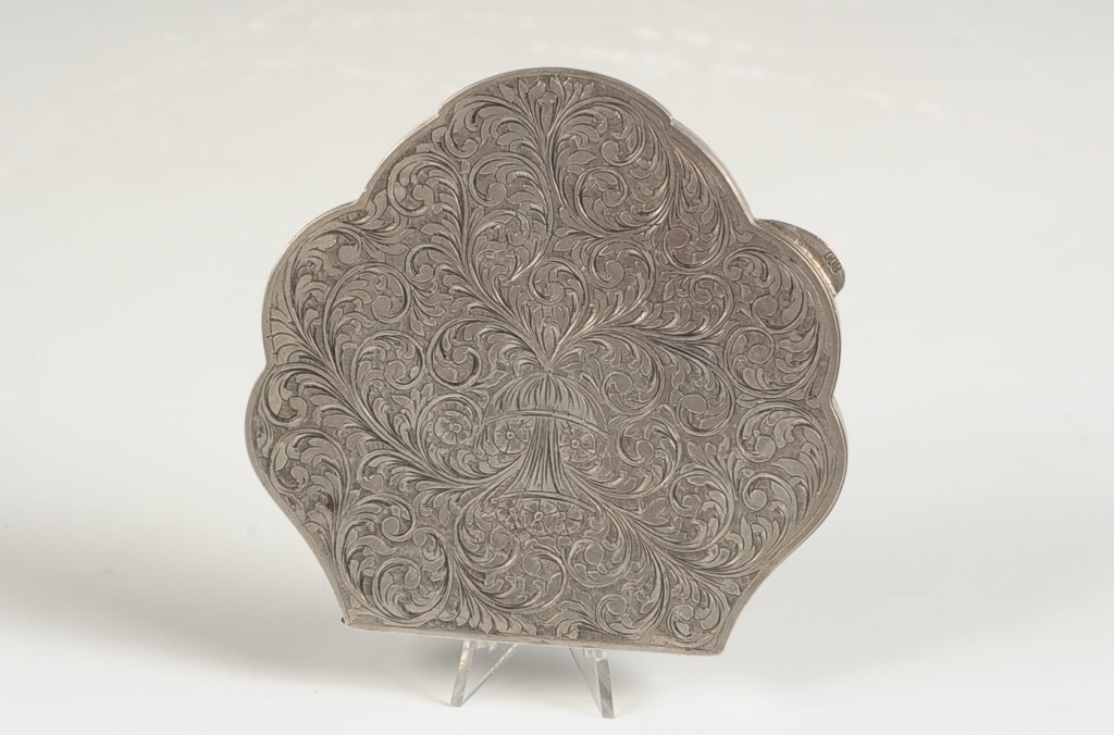 LARGE .800 CHASED SILVER COMPACT: Framed beveled mirror in the lid, marked on the catch. Measures 3.5 x 3.5 inches. Weighs 3.65 ozt.