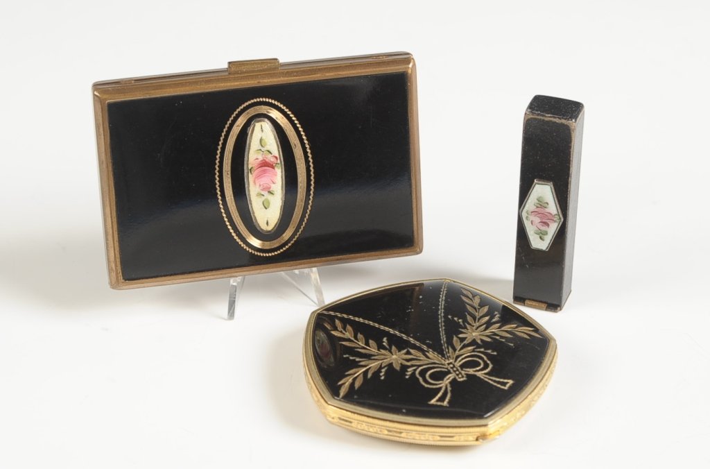 BLACK ENAMEL COMPACTS AND A LIPSTICK: Two duo compacts, one by Elgin American, and a lipstick, all in black enamel, ranging in size from 2.25 inches in length up to 2 x 3 inches.