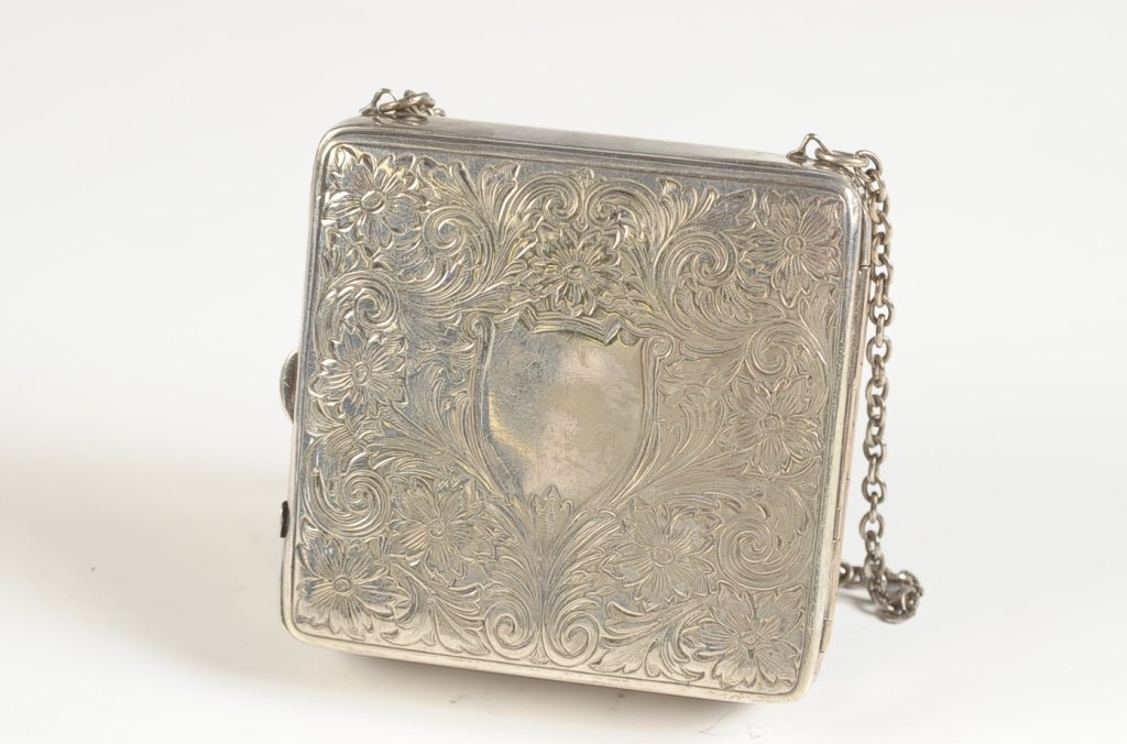LARGE VINTAGE VANITY CASE: Square vanity case with chain handle, velvet lined interior, includes lipstick, compact, perfume, button hook, mechanical pencil, and nail file. Change holders for nickels, dimes and quarters (pressur