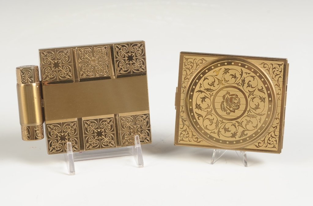 TWO VINTAGE ETCHED GOLDTONE COMPACTS: Two pieces, with one including lipstick that measures 3.5 x 2.75 inches, and the other piece measures 3 x 2.5 inches.