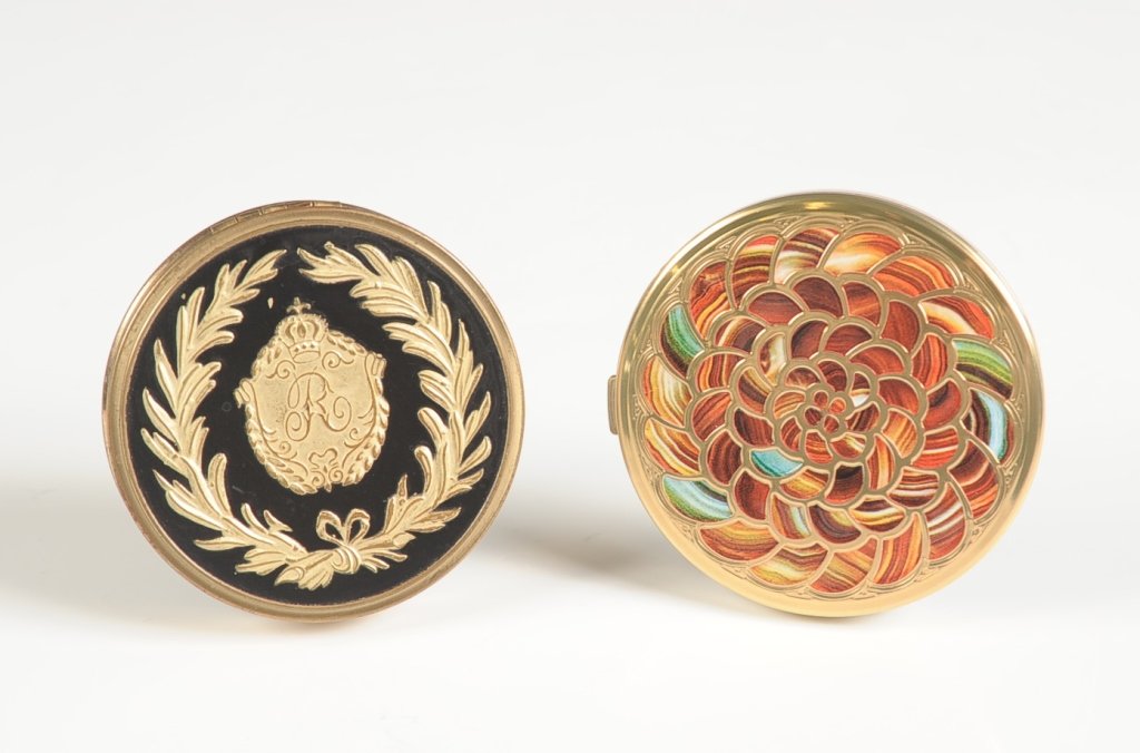 VINTAGE REVLON ENAMEL COMPACT & GUERLAIN COMPACT: Vintage Revlon compact with black enamel on goldtone, mirrored lid, pan present, marked on the bottom, measures 2.75 inches, good with a small enameled chip on top. Plus a contemporary French Guerlain