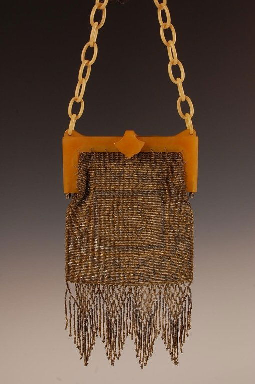 STEEL BEADED PURSE WITH A VINTAGE PLASTIC FRAME: Plastic chain handle, beaded fringe, satin lining, unmarked, measures 14.25 x 4.5 with a 6 inch drop from handle.