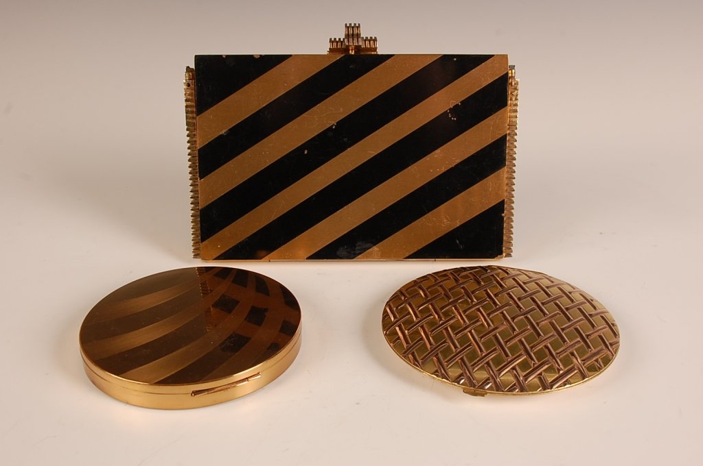 EVANS & K&K LARGE COMPACTS, PLUS A VANITY CASE: Evans goldtone compact in an embossed basket weave design, mirrored lid, mesh sifter and branded puff, marked on the mirror frame, measures 5 inches, very good. Plus a large Kotler and Kopit goldtone 