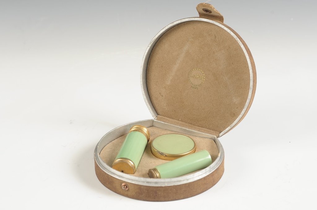 FRENCH 'LE KID' GREEN ENAMEL VANITY SET W BOX: Green enamel on goldtone compact, lipstick and a perfume atomizer in an original fitted presentation box, marked on the inside of the box lid, measures 4 x 4.25 inches.
